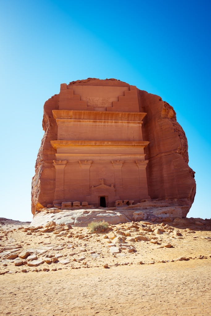 Ancient tomb at AlUla, Saudi Arabia, set against a vivid blue sky. A remarkable rock formation.